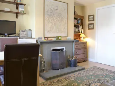 a living room with a fireplace and a tv at Causey View in Keswick