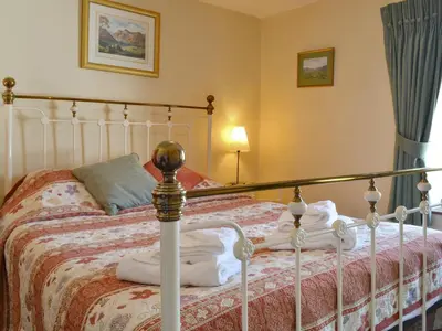 a bedroom with a bed with a white bed frame at Causey View in Keswick