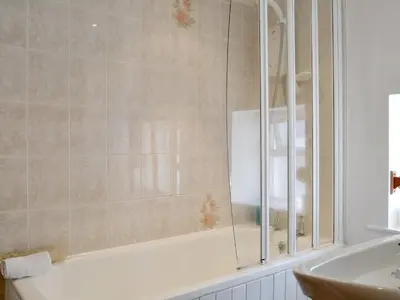 a bathroom with a bath tub and a sink at Causey View in Keswick