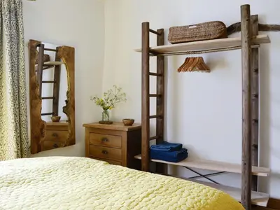 a bedroom with two bunk beds and a mirror at Springlea Cottage in Dean
