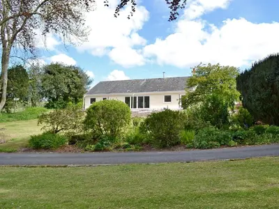 a white house on the side of a road at Lucy's At The Grange - Uk11519 in Mockerkin