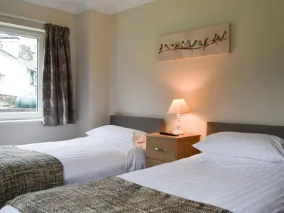 a hotel room with two beds and a window at Lucy's At The Grange - Uk11519 in Mockerkin