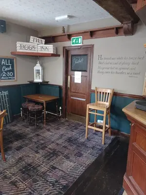 a restaurant with a table and chairs in a room at Twa Dogs Inn in Keswick