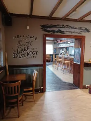 a dining room with a table and chairs at Twa Dogs Inn in Keswick
