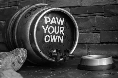 a fire hydrant with the words pay your own written on it at Twa Dogs Inn in Keswick