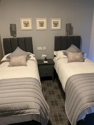 two beds sitting next to each other in a room at The Royal Hotel in Stranraer