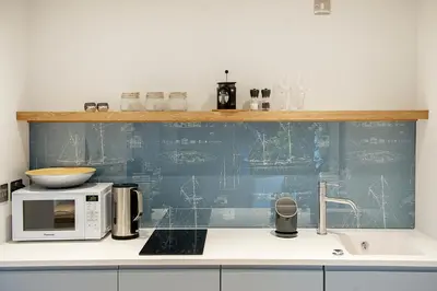a kitchen counter with a microwave and a sink at The Salt Lodge in Troon