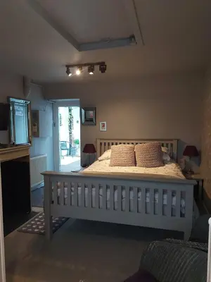 a bedroom with a large bed with pillows on it at Langside Bed and Breakfast in Fenwick