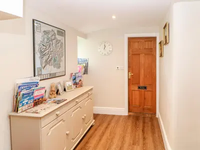 a home office with a desk and a wooden door at Berrymoor Cottage in Brampton