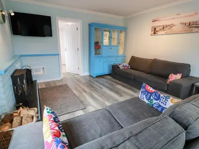 a living room with a couch and a tv at Mardan in Dumfries