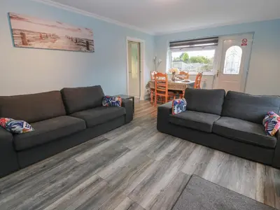 a living room with two couches and a table at Mardan in Dumfries