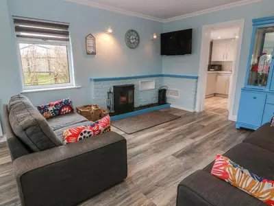 a living room with two couches and a fireplace at Mardan in Dumfries