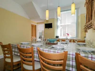 a dining room with a large table and chairs at Sefton House in Keswick