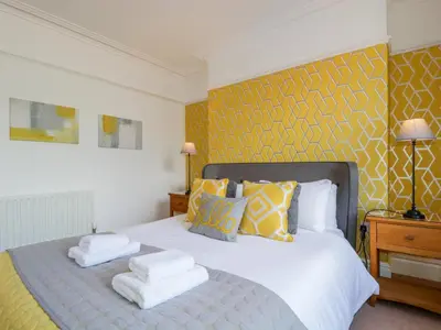 a bedroom with a bed with towels on it at Sefton House in Keswick