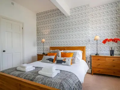 a bedroom with a bed with two towels on it at Sefton House in Keswick