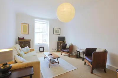 a living room with a couch and a table at 57 High Street in Kirkcudbright