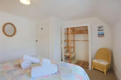 a bedroom with a bed with two towels on it at 57 High Street in Kirkcudbright