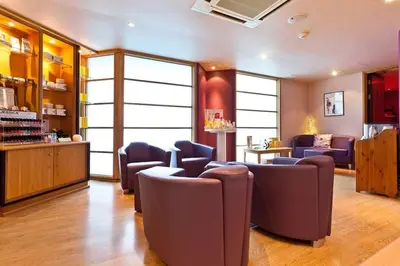 a waiting room with purple chairs and a salon at Tithe Cottage in Keswick