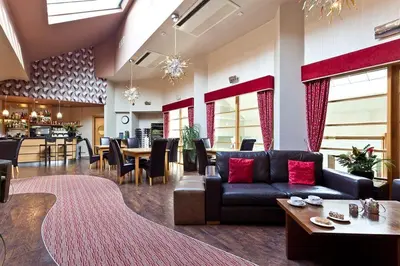 a living room with a couch and a table at Tithe Cottage in Keswick