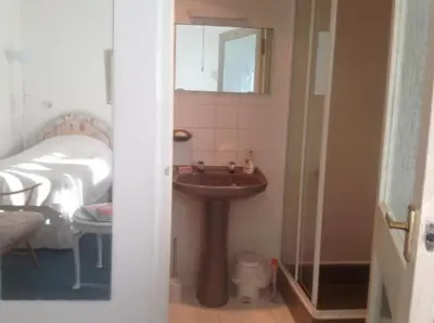 a bathroom with a sink and a toilet and a mirror at The Clan MacGregor Room in Kilmarnock