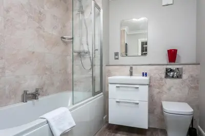 a bathroom with a sink and a shower and a toilet at Iona Residence - Donnini Apartments in Ayr