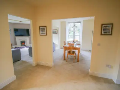 a dining room and living room with a table and chairs at Easedale Corner in Grasmere