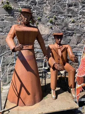 a statue of a woman and a child sitting on a chair at Providence Cottage in Kirkcudbright