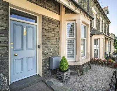 a blue door on the side of a house at 5 The Townhouse in Keswick