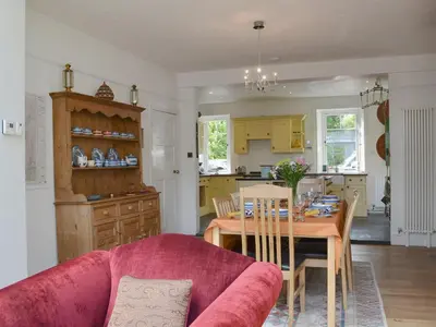a kitchen and dining room with a pink couch and a table at Trevene in Buttermere