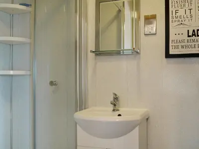 a bathroom with a sink and a mirror at Pheasant Cottage - Ukc3428 in Dalston