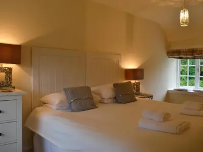 a bedroom with a large white bed with two pillows at Orchard Cottage - Uk12525 in Garlieston
