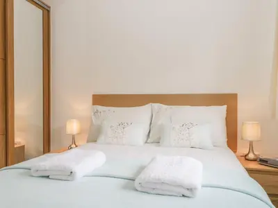 a bedroom with a bed with two towels on it at Rock Cottage in Keswick