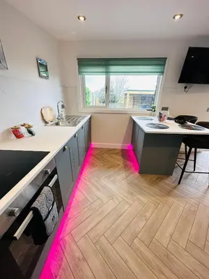 a kitchen with pink lights on the floor at Hazells Lodge Farm Stay Sleeps 2 Undercover Hottub and Pool Table in Galston