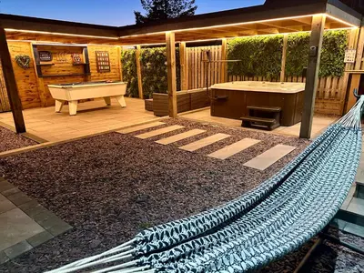 a patio with a hammock and a pool table at Hazells Lodge Farm Stay Sleeps 2 Undercover Hottub and Pool Table in Galston
