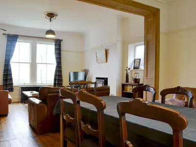 a living room with a table and chairs at Kingswood in Whitehaven