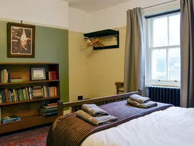 a bedroom with a bed and a book shelf at Kingswood in Whitehaven