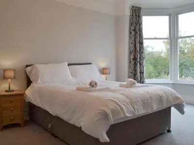 a bedroom with a bed with two towels on it at The Birches in Keswick