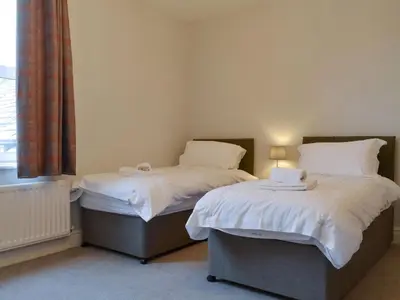 two beds sitting next to each other in a room at The Birches in Keswick