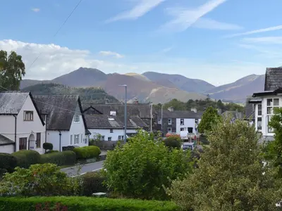 a town with houses and mountains in the background at The Birches in Keswick