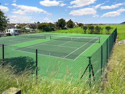 a tennis court with two tennis rackets on it at Stinchar View in Ballantrae