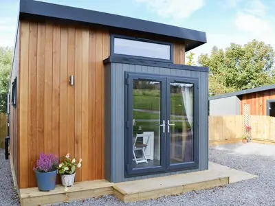 a tiny house with a black exterior at Curlew in Westward