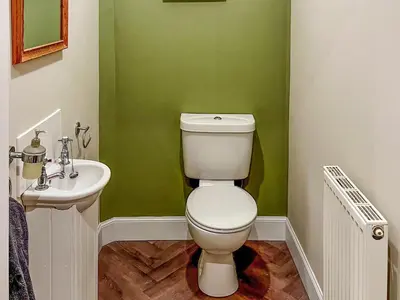 a bathroom with a toilet and a sink at Saffron in Portpatrick