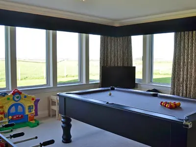 a pool table in a living room with windows at Wheatfield House in Kilmaurs