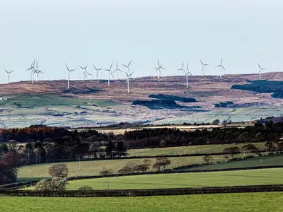 a group of wind turbines on top of a hill at Wheatfield House in Kilmaurs