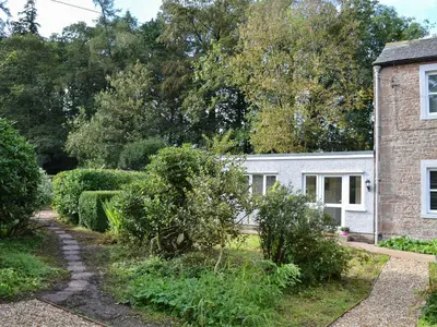 a cottage with a garden in front of it at Blaithwaite Cottage in Blencogo