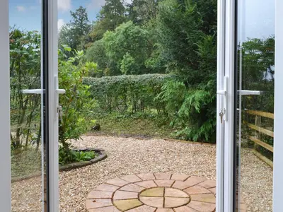 an open door with a view of a garden at Blaithwaite Cottage in Blencogo