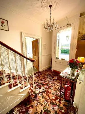 a room with a staircase with a flowered floor at Rockhill Guest House in Moffat