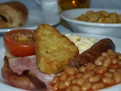 a plate of breakfast food with beans bacon beans and tomatoes at YHA Helvellyn in Glenridding