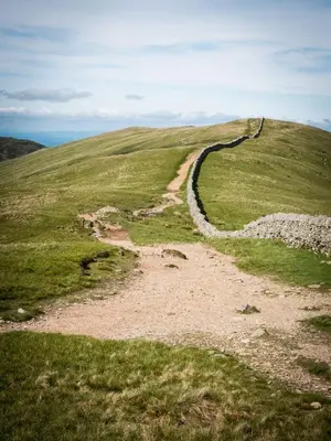 a dirt road on a grassy hill at YHA Helvellyn in Glenridding
