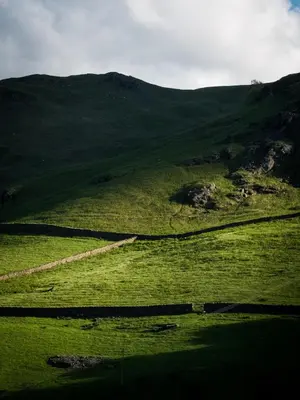 a green field with a hill in the distance at YHA Helvellyn in Glenridding